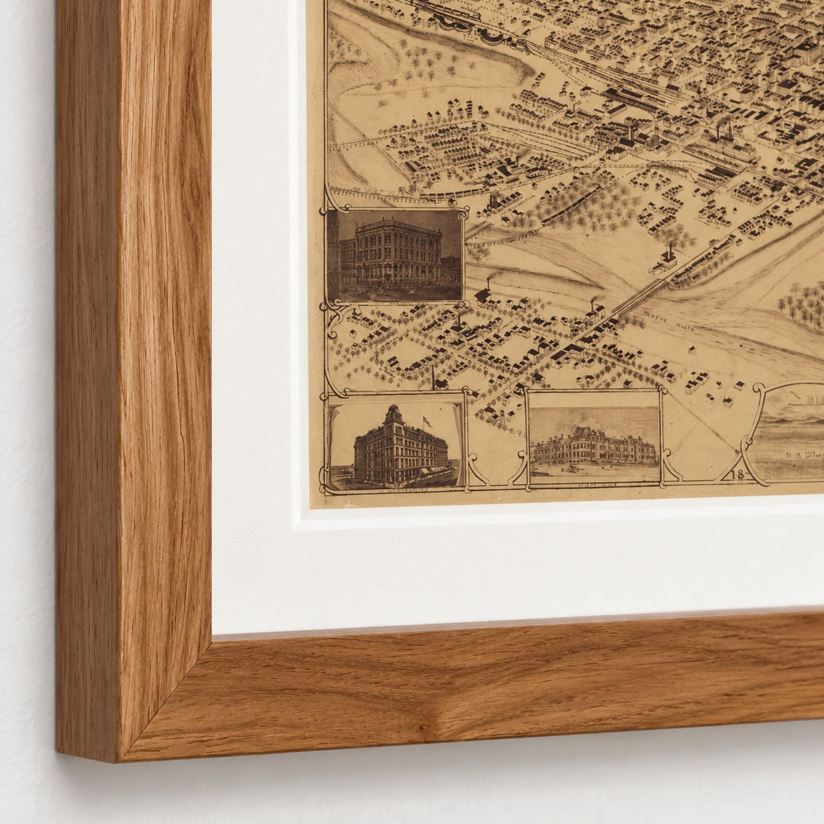 Close-up of the Denver bird’s-eye city map showing the Walnut Brown frame’s mitered corner, wood grain, and archival-white mat.