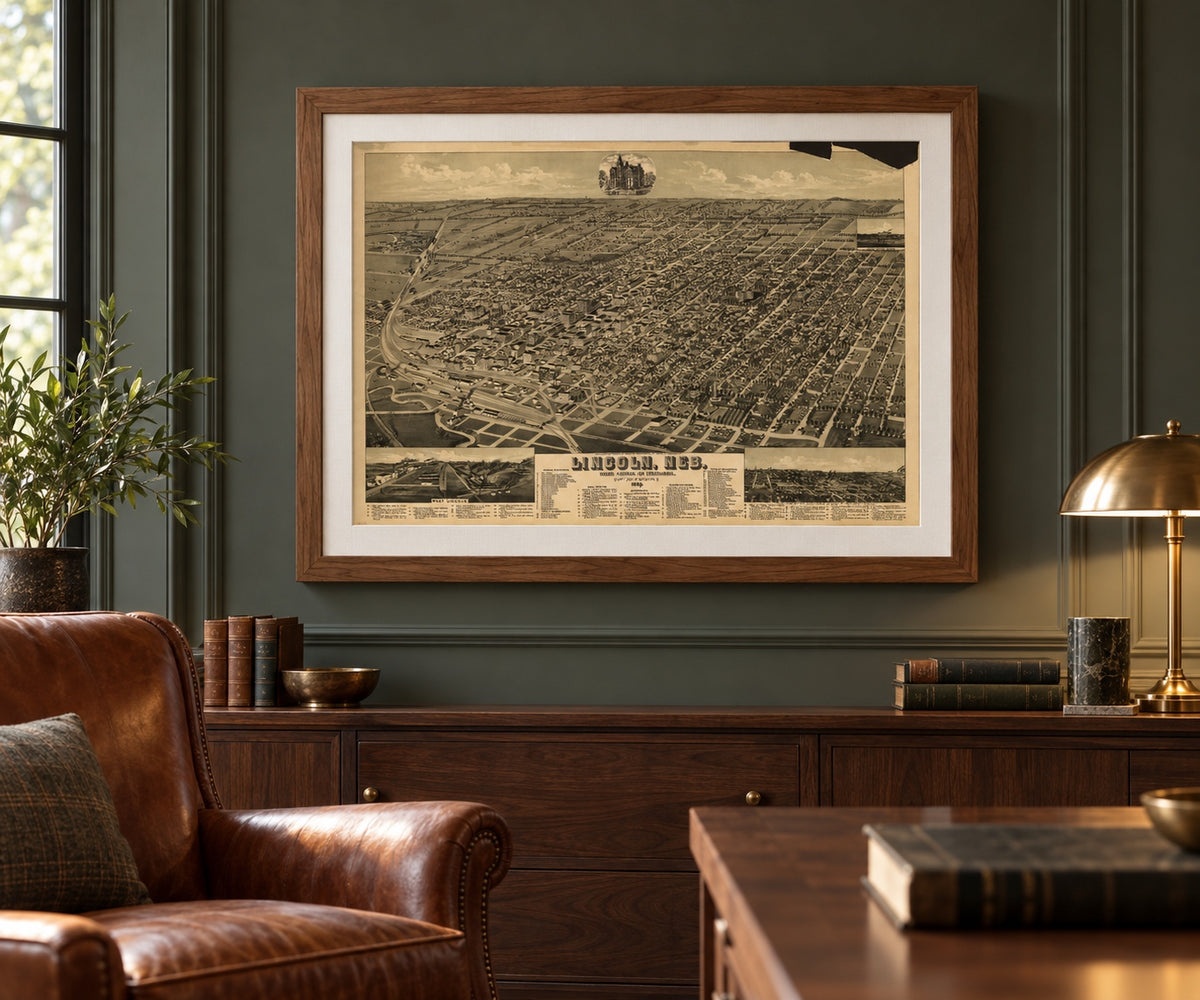Lincoln, Nebraska 1889 bird’s-eye view map in a walnut brown frame above a wood credenza in a study