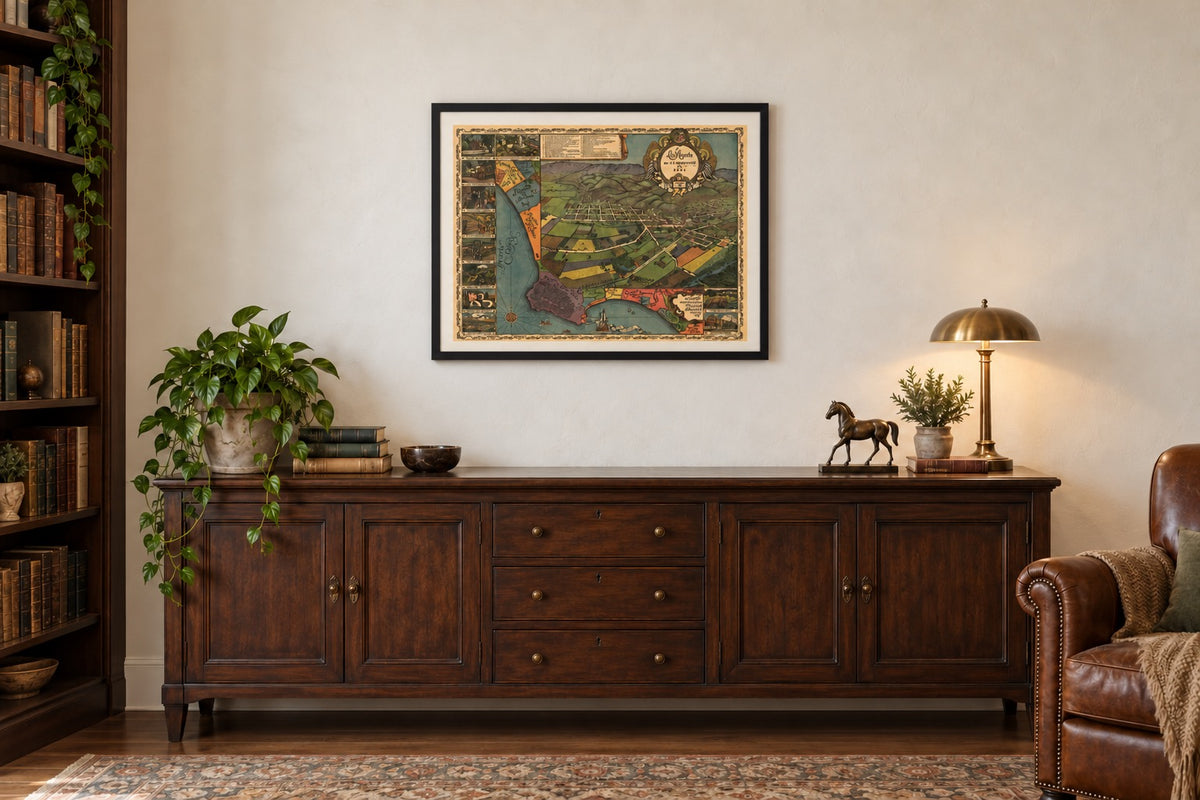 Los Angeles 1871 map in a black frame with white mat above a wood cabinet in a sunlit library.